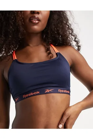 Reebok maryna seamless strappy crop top in navy and orange animal