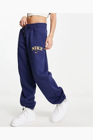 Nike Unisex retro athletics fleece joggers in midnight and gold
