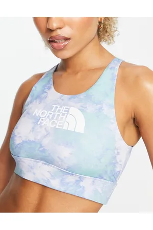 The North Face Training Tech medium support sports bra in pink tie dye  Exclusive at ASOS