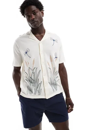 ASOS Relaxed knitted button through polo with dragonfly embroidery in ecru
