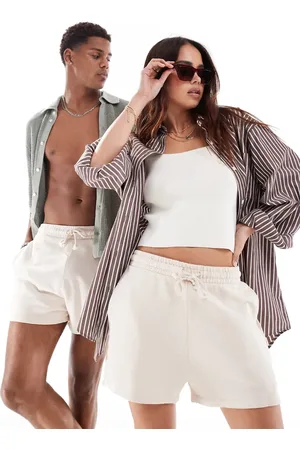 ASOS Unisex shorter length slim shorts in washed beige