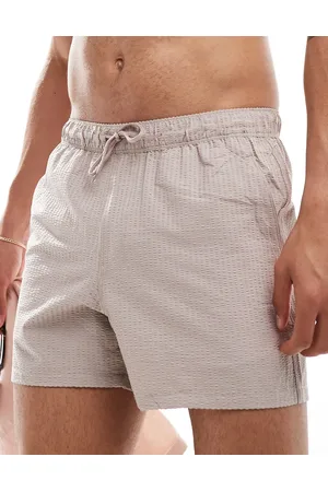 ASOS Swim shorts in short length with pocket detail in