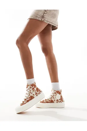 Converse Chuck Taylor All Star Hi Lift trainers in animal print