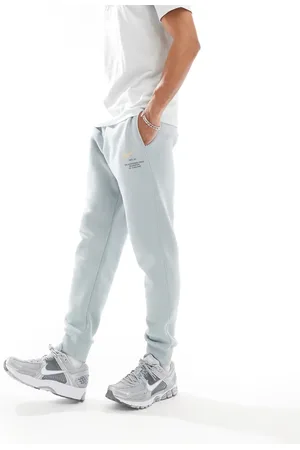 Nike Club Swoosh graphic joggers in light blue