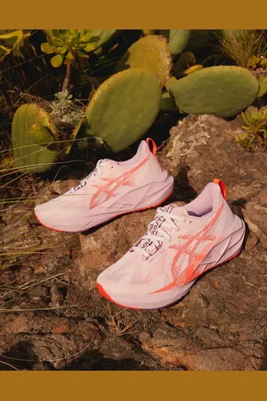 Asics Novablast 5 trainers in pink and red