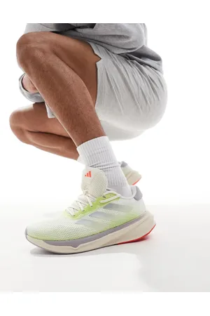 adidas Adidas Running Supernova Stride trainers in off and lime