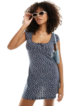 ASOS Scoop neck pointelle mini dress with bow detail in washed navy ditsy print
