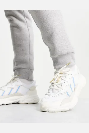 adidas Ozweego trainers in off with blue detail