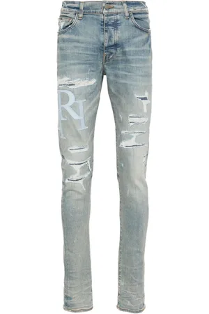 AMIRI Staggered-logo skinny jeans