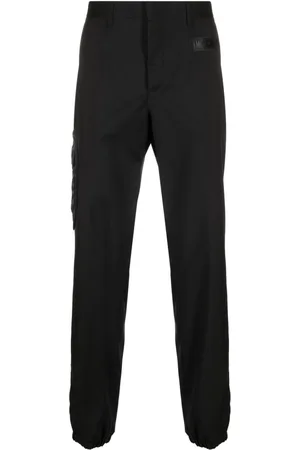 Moschino Rubberised-logo tailored trousers