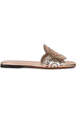 Alaïa Perforated Molukai Mules in Metallic Gold