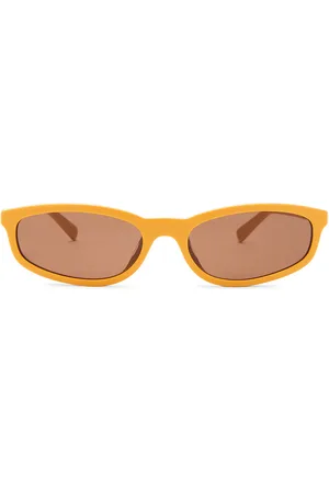 Miu Miu Oval Sunglasses in Mustard