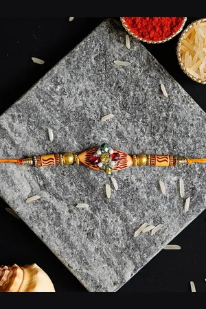 eCraftIndia Gold-Toned & Red Wooden Bhabhi Rakhi and Roli Chawal Pack