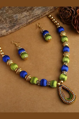 Akshara Clothing Girls Gold-Plated White & Green Stone-Studded & Beaded Silk Thread Jewellery Set