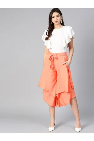 women off white peach coloured ruffled top with layered trousers
