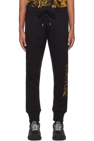 VERSACE: nylon joggers with all-over medusa heads - Black | Versace trousers  A88538 1F00539 online at GIGLIO.COM